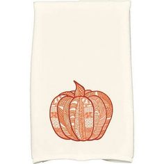 an orange and white dish towel with a pumpkin design on the front, sitting on a white surface