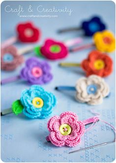 crochet flower hair pins are laying on a table