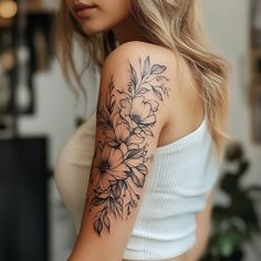 a woman with a flower tattoo on her arm