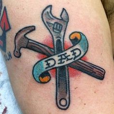 a close up of a tattoo with tools on it