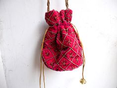 "Velvet evening purse with handwork of golden beads. Crossbody party bag with drawstring at the closure. It has an ethnic Indian touch in style and will go with western wears also like with dresses, jeans, etc. The bag is made up of velvet cloth in different color. It has a sling to hang it on the go. Can be used to gift some one or as fancy small sling bag in party or wedding. It can carry small things like mobile, wallet, etc. Dimension: maximum vertical length (of purse): 7\" vertical length Bohemian Beaded Potli Bag For Wedding, Traditional Evening Potli Bag With Latkans, Festival Beaded Potli Bag As A Gift, Beaded Shoulder Bag For Festivals Gift, Beaded Potli Bag For Festivals Gift, Beaded Potli Bag For Festivals And Gifts, Pink Shoulder Bag With Handwork For Party, Traditional Beaded Bag For Party, Festive Beaded Shoulder Bag As Gift