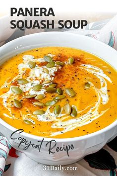 a white bowl filled with carrot soup and topped with whipped cream