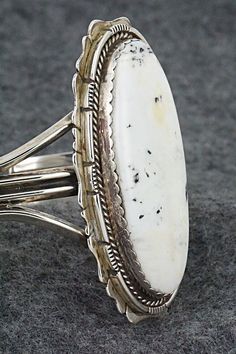 This vintage and stunning White Buffalo and sterling silver bracelet was made by a Navajo silversmith. The inside is signed L and stamped sterling.Size: 5 1/2" (will fit up to a 7" wrist)Gap: 1 1/2"Length: 2 3/8"Width: 1 1/4"Free shipping on all orders! We ship with USPS and always include tracking. All orders ship within a day of payment.Returns are accepted up to 30 days after you receive your order. Just send us a message. Our shop offers cash back or store credit. The item must be returned i Silversmithing Jewelry, White Buffalo, Boot Bag, American Jewelry, Sterling Silver Bracelet, Native American Jewelry, Turquoise Jewelry, Sterling Silver Bracelets, Air Fryer