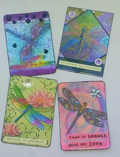 four cards with dragonflys on them and some words written in the middle one