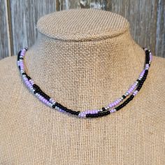 Black and Purple Two-Strand Seed Bead Choker - Seed Beed Choker - Seed Bead Necklace - Black Seed Bead Choker - Purple Seed Bead Choker This 2-strand choker features black, purple  and silver seed beads.   Both strands are the same length.   Contains a single silver-plated lobster clasp with 3-inch extender chain. Choker is 15 to 18 inches around. Seed Bead Patterns Free Necklaces, Seed Bead Designs, Seed Bead Patterns Free, Bored Jar, Seed Bead Choker, Purple And Silver, Bead Choker, Beaded Necklace Diy, Seed Bead Patterns