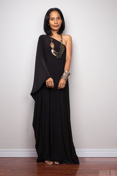 "Black one shoulder dress, Long black kaftan dress, Off shoulder evening dress, black cocktail dress, black party dress, reversible dress PRODUCT SIZE : Free Size * Chest : 40\" will stretch to 44\" * Waist : 40\" will stretch to 44\" * Hips : 40\" will stretch to 44\" * Sleeve length : 23\" * Length : 57\" - 58\" from shoulder to hem (measured when laying flat) MATERIAL : * ITY (polyester jersey) > soft and comfortable to wear, not as slippery as spandex. NOTE : * Model chest : 32\", waist : Bohemian One Shoulder Evening Dress, Bohemian One-shoulder Evening Dress, Black Asymmetrical One Shoulder Evening Dress, Black Off-shoulder Maxi Dress For Gala, Elegant Black One Shoulder Maxi Dress, Black Floor-length One-shoulder Cocktail Dress, Bohemian Draped Maxi Dress For Party, Black One-shoulder Floor-length Party Dress, Black One Shoulder Floor-length Party Dress