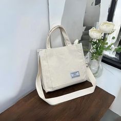 Cream Corduroy Mini Tote Bag - a practical addition to your everyday style! Made from soft corduroy material. Its a simple design to match with any casual outfit.  Internal zipper compartment and an outer pocket for quick access, you can keep your essentials like keys, phone, or makeup safe and secure while you're out and about. A adjustable strap for crossbody of shoulder or just over the arm.  The mini tote bag is durable yet stylish, adding a touch of flair to your accessory collection. Its c Casual Beige Canvas Bag With Mobile Phone Holder, Casual Beige Canvas Bag With Mobile Phone Pocket, Vintage Cotton Crossbody Bag, Casual Cotton Shoulder Bag With Mobile Phone Pocket, Everyday Cotton Mobile Phone Bag, Daily Use Cotton Mobile Phone Bag, Rectangular Cotton Shoulder Bag With Mobile Phone Pocket, Vintage Boho Style, Tote Bag With Zipper