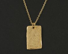 Simple gold rectangle necklace featuring a textured gold pendant. The edges are not entirely smooth and they have a distressed texture that make them look like relics from long ago. Charms are manufactured in the US and are made of pewter that meet CPSIA standards. Charms are 3/4 inches tall and 1/2 inches wide (1.9 x 1.3 cm). Your choice of necklace length - 18 or 20 inches. Thank you for stopping by! Find more handmade necklaces here - https://www.etsy.com/shop/BeautifulByCharlene?section_id=13383312 Enter my shop here - https://www.etsy.com/shop/BeautifulByCharlene Gold Hammered Rectangular Jewelry, Hammered Gold Rectangular Jewelry, Gold Rectangular Brass Necklace, Rectangular Gold Brass Necklace, Rectangle Necklace, Distressed Texture, Minimalist Contemporary, Rustic Jewelry, Modern Necklaces