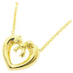 TIFFANY & Co. 18K Yellow Gold Ribbon Bow Heart Pendant Necklace Metal: 18K Yellow Gold Chain: 16" long Measurement of pendant: 12.5mm wide Weight: 3.80 grams Hallmark: "TIFFANY&Co. ©1991 750" on the pendant, "TIFFANY&CO. 750" on the chain tags Condition: Excellent condition, like new Limited edition, no longer available for sale in Tiffany stores Authenticity guaranteed Cupids Bow, Bow Necklace, Gold Ribbon, Tiffany And Co, Gold Ribbons, Yellow Gold Chain, Ribbon Bow, Metal Necklaces, Heart Pendant Necklace