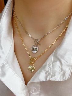 1.Our Heart Shape pendant sparkles as it sits in a halo of cubic zirconia gems. Simple yet elegant, our faux diamond necklace is a classic necklace for every woman; 2.You'll never get tired of seeing the sparkle from all angle! Cubic Zirconia is tougher and will not chip as easily or lose brilliance as fast thus making it a good choice for buyers looking for excellent jewelry at reasonable price; 3.Heart necklaces for women looks great with anything! This charm necklace for women is a lovely sil Valentine's Day Cubic Zirconia Jewelry With Heart Charm, Dainty Silver Plated Charm Necklaces, Elegant Silver Plated Charm Necklaces, Elegant Silver Charm Necklace, Cubic Zirconia Heart Pendant Clavicle Chain, Silver Plated Pendant Charm Necklace, Valentine's Day Diamond Accented Necklace For Her, Valentine's Day Gift Necklaces With Diamond Accents, Heart Shaped Necklace With Diamond Accents For Her