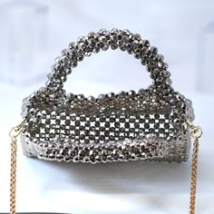 New to our Millennium collection, This beautiful romantic Silver Gold Beaded bridal bag is made of very fine quality of Shinning Beads and metal and it comes with Chain 46 inches long for cross body bag Detachable chain for your Big day! The Bag measure about 7 inches long(including handles) 4.5 inches long( without handles), 7 inches wide and thickness of the bag 2 inches  ► ABOUT YOUR ORDER * All items are neatly packaged in our beautiful jewelry boxes and elegant organza bags. * All items are Luxury Gold Clutch With Sequins, Luxury Gold Sequin Bag, Luxury Gold Sequin Clutch, Gold Sequined Shoulder Bag For Evening, Elegant Gold Sequined Shoulder Bag, Glamorous Rectangular Sequin Shoulder Bag, Gold Handheld Shoulder Bag For Celebration, Silver Top Handle Bag For Wedding, Silver Top Handle Evening Bag For Wedding