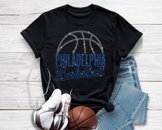 Philadelphia Basketball Game Day Rhinestone Shirt, Motivational Sports Teams Shirt, Stylish Design Sports Shirt, Fans Gift for Him or Her Created for those who carry their team spirit into every game, this rhinestone-adorned basketball shirt blends style and motivation effortlessly. It's a standout gift choice for any sports fan, offering a perfect balance between comfort and flair. Made from premium-quality fabric with a unisex fit, this shirt ensures you stay cozy throughout the day while keeping your style game strong. Whether you're cheering from the stands or out and about, its retro charm and sparkling details make it a wardrobe favorite. Ideal for anyone who loves to showcase their passion and motivation on and off the court. Comfortable and Stylish: Made from soft, breathable fabri Rhinestone Shirt, Rhinestone Shirts, Sport Design, Sports Shirt, Basketball Shirts, Basketball Game, Basketball Games, Sport Shirt, Team Shirts