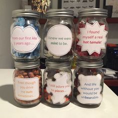 four glass jars filled with different types of candy