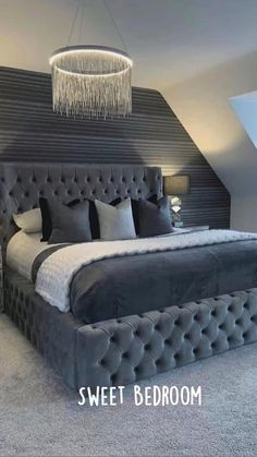 a large bed sitting in the middle of a bedroom next to an attic style ceiling