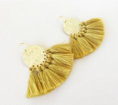 "Mini cotton tassels (1.25\") decorate a lightweight brushed gold plated Circle (1\"). Gold plated (16k) ear hook Weight: 0.12 ounce each" Adjustable Gold Tassel Earrings With Fringe, Bohemian Gold Tassel Earrings With Fringe, Adjustable Gold Bohemian Tassel Earrings, Gold Bohemian Tassel Earrings With Fringe, Yellow Tassel Earrings, Gold Wrap, Greenville Sc, White Earrings, Ear Hook