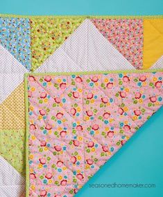 a quilted triangle with flowers on it