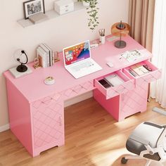 a pink desk with a laptop on it