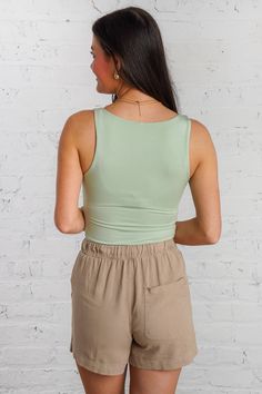 Introducing the Kodiak Tank, the slim high neck tank top that will elevate your wardrobe. Made from soft, breathable material in a refreshing mint color, this double-lined tank is perfect for layering or wearing alone on warm days. Pair it with our sand dune shorts for a stylish and comfortable look. It is lightweight, non-sheer, and fits true to size. 95% Rayon, 5% Spandex Brand- Be Cool Model is 5'5" and is wearing a small High Neck Tank Top, High Neck Tank, Mint Color, New Arrival Dress, Layering, High Neck, Tank Top, Mint, Spandex