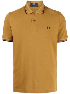 logo-embroidered cotton polo shirt from FRED PERRY featuring ochre brown, cotton, stripe trim, embroidered logo at the chest, polo collar, front button placket, short sleeves and straight hem. Size Info US Color Detail Brown Made In U.K. Material Exterior: 100% Cotton Season One Fall-Winter Season Two Fall-Winter Product t-shirts and polos Brand Fred Perry Size And Fit This piece fits true to size. We recommend you get your regular sizeModel is 1,84m / 6ft 1in wearing size 40 (UK/US) Fred Perry Logo, Fred Perry T Shirt, Polo Shirt Logo, Fred Perry Shirt, Yellow Polo Shirt, Cape Coat, Cotton Polo Shirt, Cotton Polo, Pant Shirt