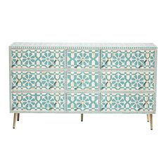 a blue and white dresser with geometric designs on the front, two drawers and three doors