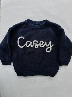 Navy Hand embroidered name sweater  Sweaters are an oversized fit, chunky knit Please choose from the colors in photos for letter color options  PERSONALIZATION:  Type the name EXACTLY as you would like it embroidered. If you would like the name in all lowercase, please type it that way. It will be created just as it's written in the order.  Clearly list the color you would like for the name. If you would like a design, please include colors for that too. If no colors are listed they will be cho Oversized Fall Sweater With Letter Embroidery, Oversized Letter Embroidery Sweater For Fall, Oversized Winter Sweater With Letter Embroidery, Blue Sweater With Embroidered Text For Fall, Blue Winter Sweater With Embroidered Text, Blue Embroidered Text Sweater For Fall, Winter Blue Sweater With Embroidered Text, Blue Fall Sweater With Letter Embroidery, Blue Sweater With Letter Embroidery For Fall