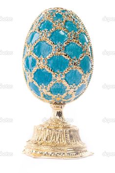 an ornate blue and gold decorated egg on a white background stock photo 94978