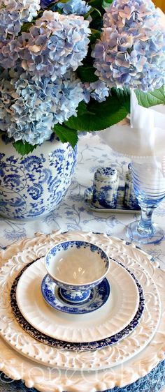 the table is set with blue and white dishes