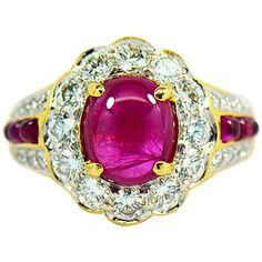 This Majestic natural Ruby ring with diamond halo is a real show stopper. Featuring a 2.42 carat rich red oval cabochon Ruby that scream with passion. The center ruby is set in four prongs surrounded by a diamond halo of 12 round brilliant diamonds. The beautiful bright red Ruby is full of life and is contrasted by the beautiful white brilliant diamonds on the halo. The scalloped design around the diamonds resembles a flower shape around the center ruby. The ring is masterfully crafted in 18k ye Cabochon Ruby, Natural Ruby Ring, Diamond Halo Ring, Be Natural, Halo Diamond Ring, Vintage Jewels, Ruby Diamond, Halo Ring, Ruby Ring