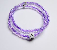 This set of two light purple seed bead bracelets is personalized with an initial of your choice. The beads are on a stretch cord and fits most sizes. The purple color of the beads is so pretty. Personalized gifts are special gifts to give to special people.  This is a stackable bracelet set.  Seed beaded bracelets make great christmas gifts, gift for her, or treat yourself.  You receive it in a gift box and it is ready to give.  Made on the top of the mountain with fresh air and beautiful views.  Please let me know initial you choose at checkout. Lavender Bracelets With Tiny Beads For Gift, Lavender Beaded Bracelet With Tiny Beads For Gifts, Purple Stretch Bracelet With Tiny Beads As Gift, Purple Letter Beads Stretch Bracelet For Birthday, Purple Stretch Bracelet With Letter Beads For Birthday, Adjustable Lavender Beaded Bracelets With Letter Beads, Personalized Purple Stretch Bracelet With Round Beads, Personalized Purple Round Beads Stretch Bracelet, Purple Stretch Bracelet With Letter Beads For Gift