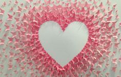 a heart shaped frame made out of pink paper