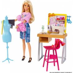 a barbie doll is standing next to a sewing table