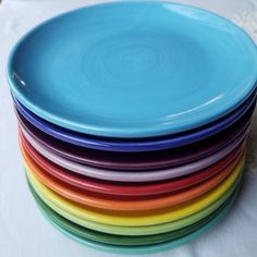 a stack of colorful plates sitting on top of a table