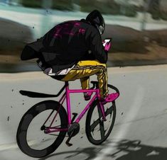 a man riding a pink bike down a street