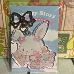 an animal shaped keychain with a bow on it's head in a package