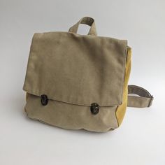 "Khaki Green Satchel Backpack, Backpack Purse, Canvas Rucksack, Vegan Eco Friendly Backpack, Laptop Backpacks, Retro Satchel Purse This lovely satchel backpack bag is a classic and nostalgic one. The bag closes with 2 front bronze clips which integrate beautifully with the fabric colors. The Satchel Backpack can serve you to work, college and even as a diaper bag. it is unique and 100% vegan! ** SPECIFICATIONS ** Features: + Wide adjustable shoulders straps to fit any height. + One internal pock Khaki Large Capacity Backpack For School, Khaki Canvas School Bag With Removable Pouch, Khaki Rectangular Canvas Bag For School, Khaki Large Capacity School Backpack, Rectangular Khaki Backpack For Travel, Beige Canvas Backpack For School, Everyday Khaki Backpack Shoulder Bag, Khaki Softback Backpack With Large Capacity, Everyday Khaki Canvas Backpack