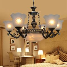 a chandelier hanging over a bed in a bedroom