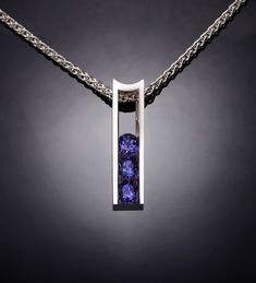 "Alexandrite Necklace - Argentium Silver - 3503 - Argentium Chain Included Make a statement with this modern artisan crafted pendant. Cast in high purity Argentium 960, 100% recycled silver, this pendant measures 22mm x 6mm (7/8\" x 1/4\") and is channel set with three beautiful 4mm Chatham Alexandrites. ( IMPORTANT - PLEASE READ 1. AND 2 BELOW ) 1.) INCLUDED IN THE PRICE IS AN ARGENTIUM SILVER CHAIN APPROPRIATE FOR THE PENDANT CHOSEN. YOU CAN CHOOSE FROM 16\", 18\" OR 20\" LENGTH AT CHECKOUT. 2 Emerald Birthstone Jewelry, Pink Topaz Necklace, Alexandrite Necklace, Argentium Silver Jewelry, Elegant Rings, Yucca Valley, Peridot Pendant, Blue Topaz Necklace, Peridot Necklace