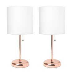 pair of rose gold metal table lamps with white linen shades on each lamp and one light in the middle