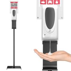 a person holding out their hand in front of a public phone booth with red and white stickers on it