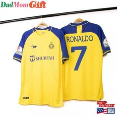 a yellow and blue soccer jersey hanging on a clothes line with the number seven printed on it