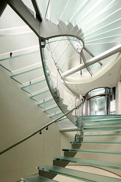 an image of a staircase going up to the top floor with glass railings on both sides