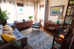 a living room filled with furniture and lots of windows