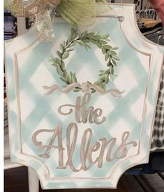 a sign that says the aldens with a wreath on it's side