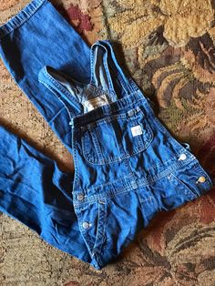 Vintage Ralph Lauren Overalls Sweet little miniature version of the classic workwear staple Workwear style denim with tons of style and pockets Comfy, soft, distressed wash denim  Great, flexible closet staple Buttons on hips to get on and off easily Adjustable 2 buttons for straps Polo Ralph Lauren Listing is for the overalls only; not display pieces or other apparel or decor Size Childs size 7 Approximate measurements in inches (lying flat): -waist: 12-13 -hip:14 -length:43 -inseam:21 Everyday Dark Wash Overalls With Pockets, Straight Leg Medium Wash Overalls For Workwear, Dark Wash Distressed Overalls, Utility Denim Jumpsuit With Patch Pockets, Distressed Dark Wash Cotton Overalls, Distressed Cotton Overalls In Dark Wash, Dark Wash Distressed Cotton Overalls, Medium Wash Distressed Denim Jumpsuit, Utility Style Medium Wash Jeans