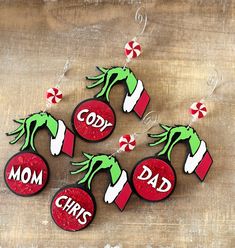 christmas ornaments made to look like the grin's teeth are hanging on a wooden table