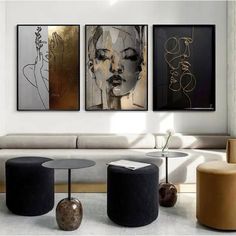 three paintings hang on the wall in a living room