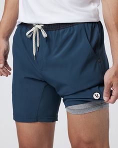 One short for every sport, the Kore Shorts have a classic athletic fit, falling just above the knee with an anywhere and everywhere versatility. Go commando in confidence with the breathable, boxer-brief liner.Also available in 5" and 9" inseam. | Vuori Kore Shorts | Indigo | XXL Vuori makes premium performance apparel inspired by the active Coastal California lifestyle; an integration of fitness, surf, sport, and art. Breaking down the boundaries of traditional activewear, we are a new perspect Navy Activewear With Built-in Shorts For Gym, Athleisure Boxer Briefs With Built-in Shorts For Running, Recycled Polyester Bottoms With Built-in Shorts For Training, Sporty Boxer Briefs With Elastic Waistband For Workout, Sporty Boxer Briefs For Workout With Elastic Waistband, Sporty Compressive Athletic Shorts For Outdoor, Navy Activewear With Built-in Shorts For Training, Sporty Navy Bottoms For Outdoor Activities, Sporty Navy Bottoms For Outdoor