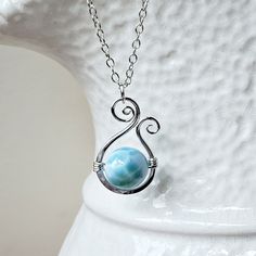 Made to order. Current production times for made to order items can be found in the shop announcement or on the shop policies page. A stunningly beautiful round larimar stone is suspended within a paisley frame. The larimar spins freely so there will always be a different side of this gorgeous gemstone to see. *Sterling silver is pictured. ~ 10mm round larimar, aquamarine ~ gold filled, sterling silver, or rose gold filled wire, clasp, and chain ~ 14-22 inches (35.6-55.9 cm) long; for longer cha Blue Larimar Jewelry For Jewelry Making, Nickel Free Larimar Jewelry For Gifts, Spiritual Round Larimar Jewelry, Handmade Larimar Round Necklace, Handmade Round Larimar Necklaces, Handmade Blue Larimar Jewelry, Round Larimar Jewelry For Gifts, Round Larimar Jewelry Gift, Larimar Beaded Jewelry For Gifts