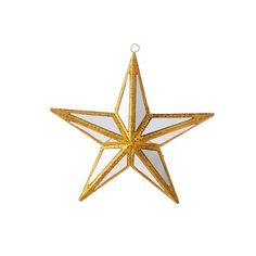 a gold and white star ornament hanging on a wall