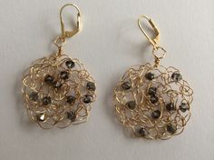 Swavorski crystals are crocheted into gold plated wire to create a lacy sparkling golden circle. Light and airy, goes with formal or casual attire. These versatile earrings are elegant enough for weddings, casual enough for everywhere else.  The first two photos are in swavorski crystal silver night, a stunning soft smokey black. Photo three is clear crystal, photo four and five is light topaz crystal. The earrings are for pierced ears and made with gold filled ear wires.  They hang 2 1/4 long ( Elegant Gold Wire-wrapped Crystal Earrings, Elegant Gold Crystal Earrings Wire Wrapped, Elegant Gold Wire Wrapped Crystal Earrings, Gold Wire Wrapped Crystal Earrings For Wedding, Gold Wire-wrapped Crystal Earrings, Gold Wire Wrapped Earrings For Party, Gold Wire Wrapped Crystal Earrings, Earring Crochet, Crochet Wire